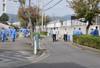 Employees cleaning their local area in Kobe