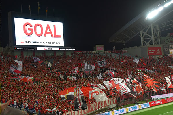 Supporters cheer as the Urawa Reds score a goal
