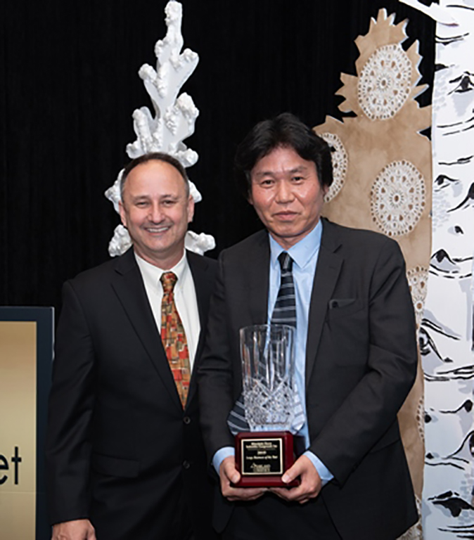 Manabu Saga & Lawrence Rominger accept the award for "Business of the Year".