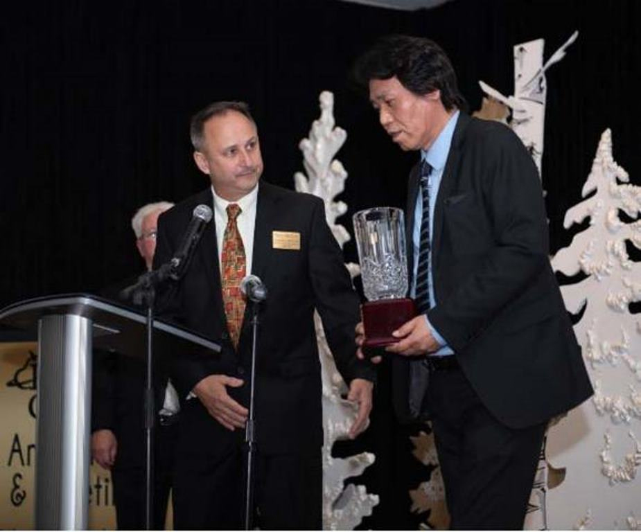 Manabu Saga & Lawrence Rominger accept the award for "Business of the Year".