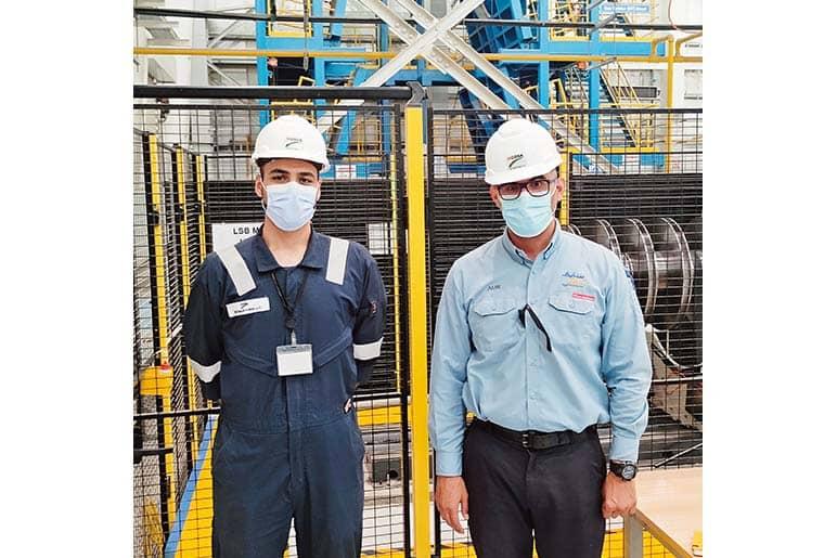 Hadeem (left), an employee, performing an inspection with a customer (right) present