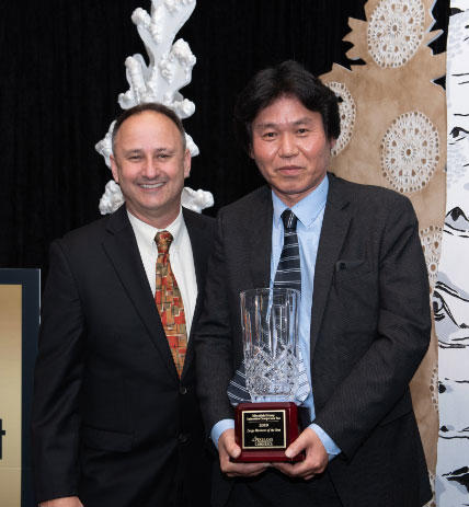 Manabu Saga & Lawrence Rominger accept  the award for “Business of the Year”.