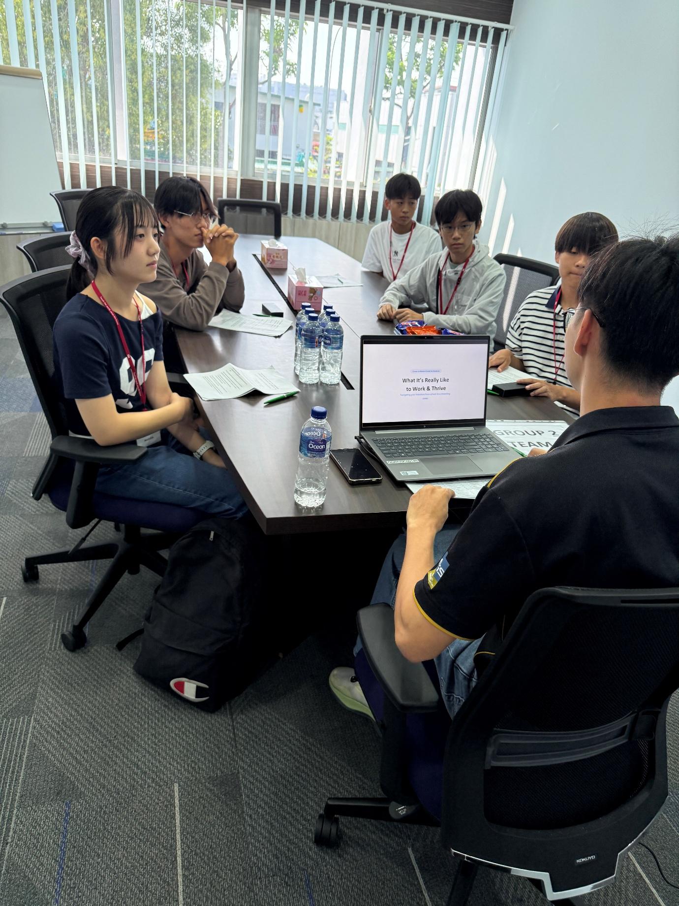 Japanese high school students in a breakout discussion with an MHI-ESA employee