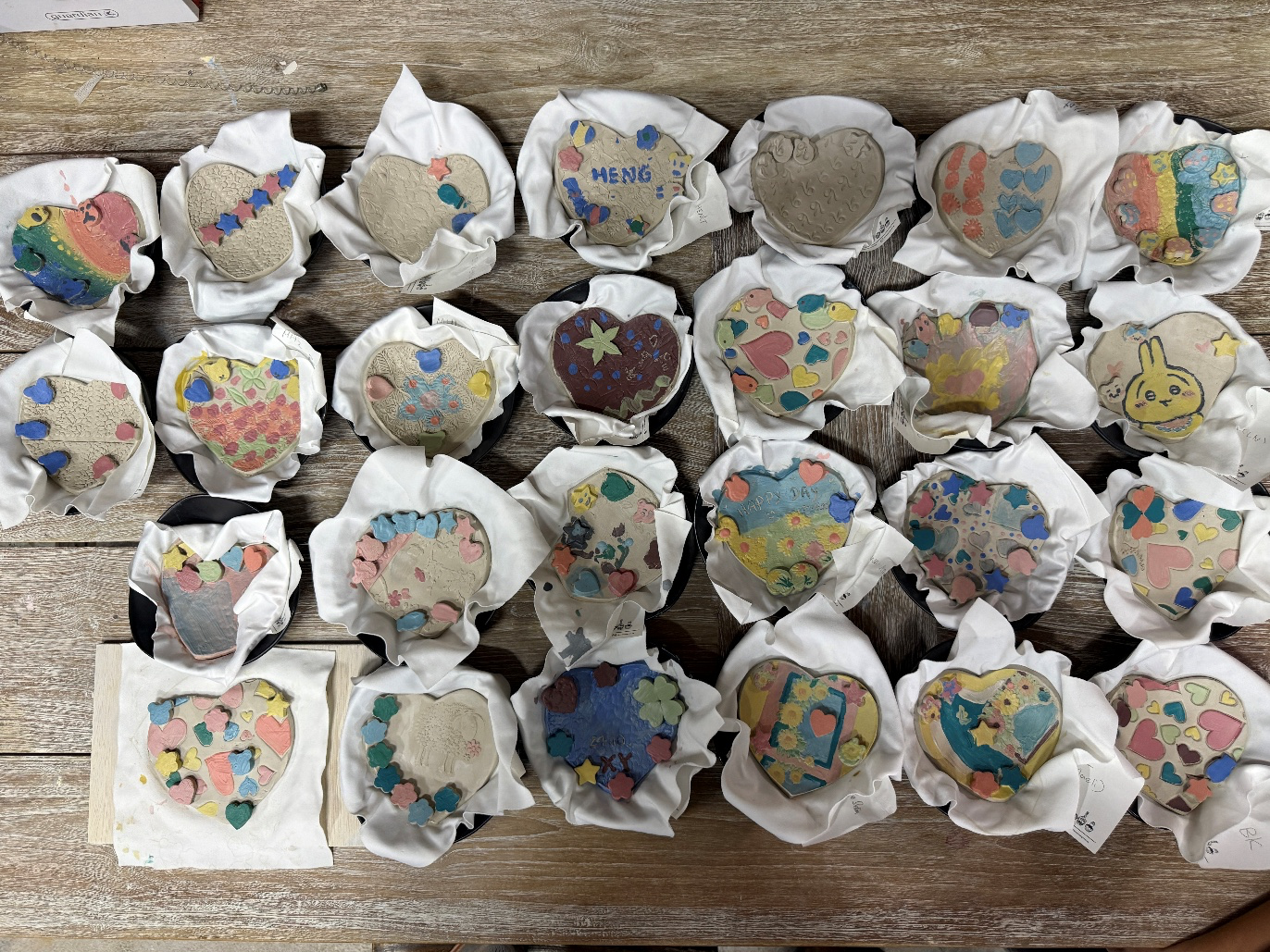 Finished heart-shaped pottery dishes displayed together