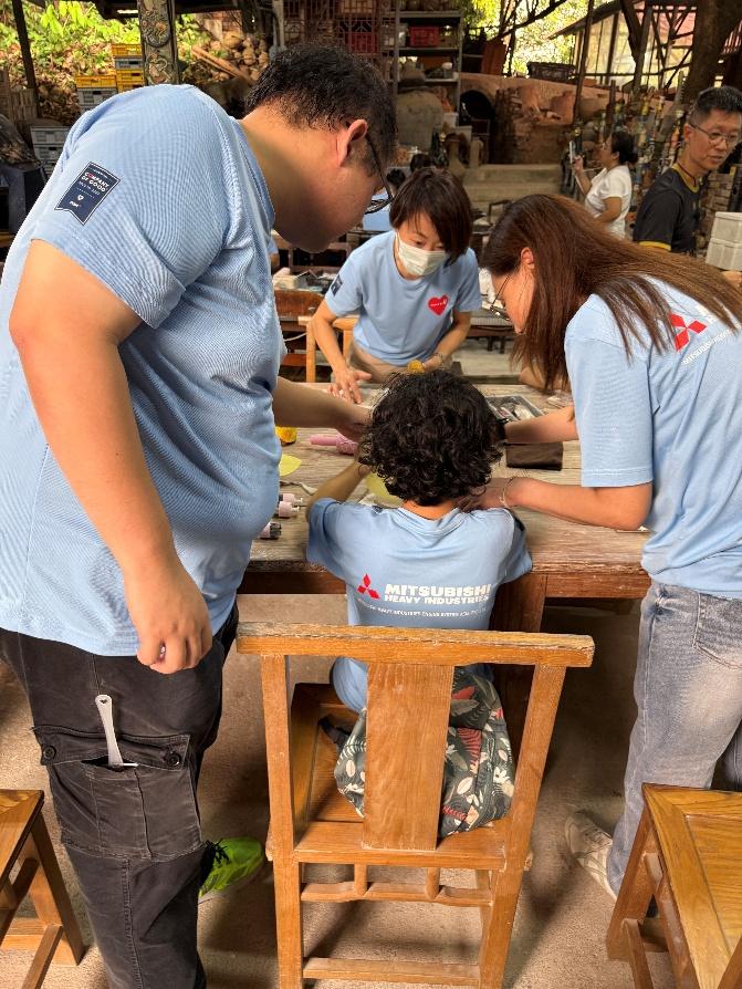 Volunteers and Marymount Centre participants making pottery together