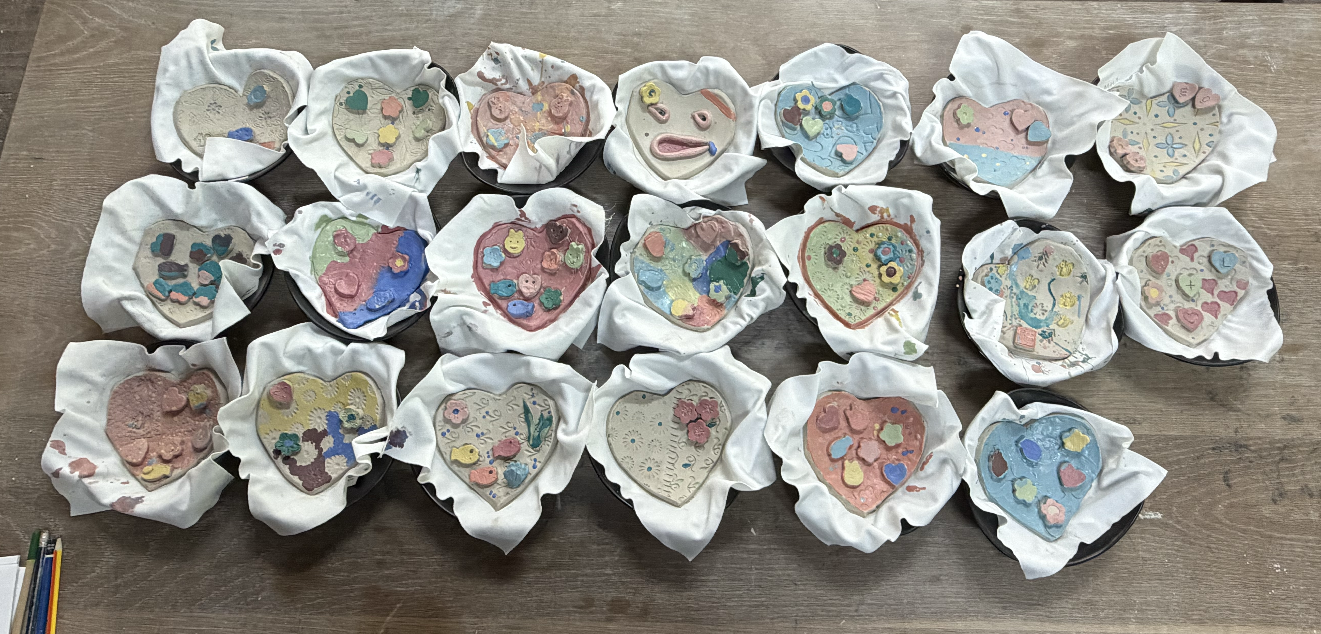 Colourful heart-shaped pottery trinket dishes created during the workshop