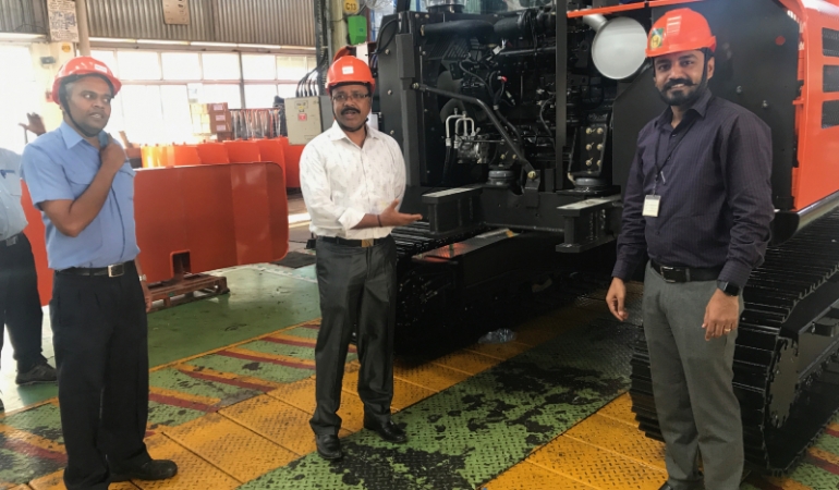 Three people of MVDE team with engine