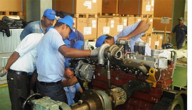 MVDE India workers working on a compact, lightweight, and rugged mitsubishi diesel engine