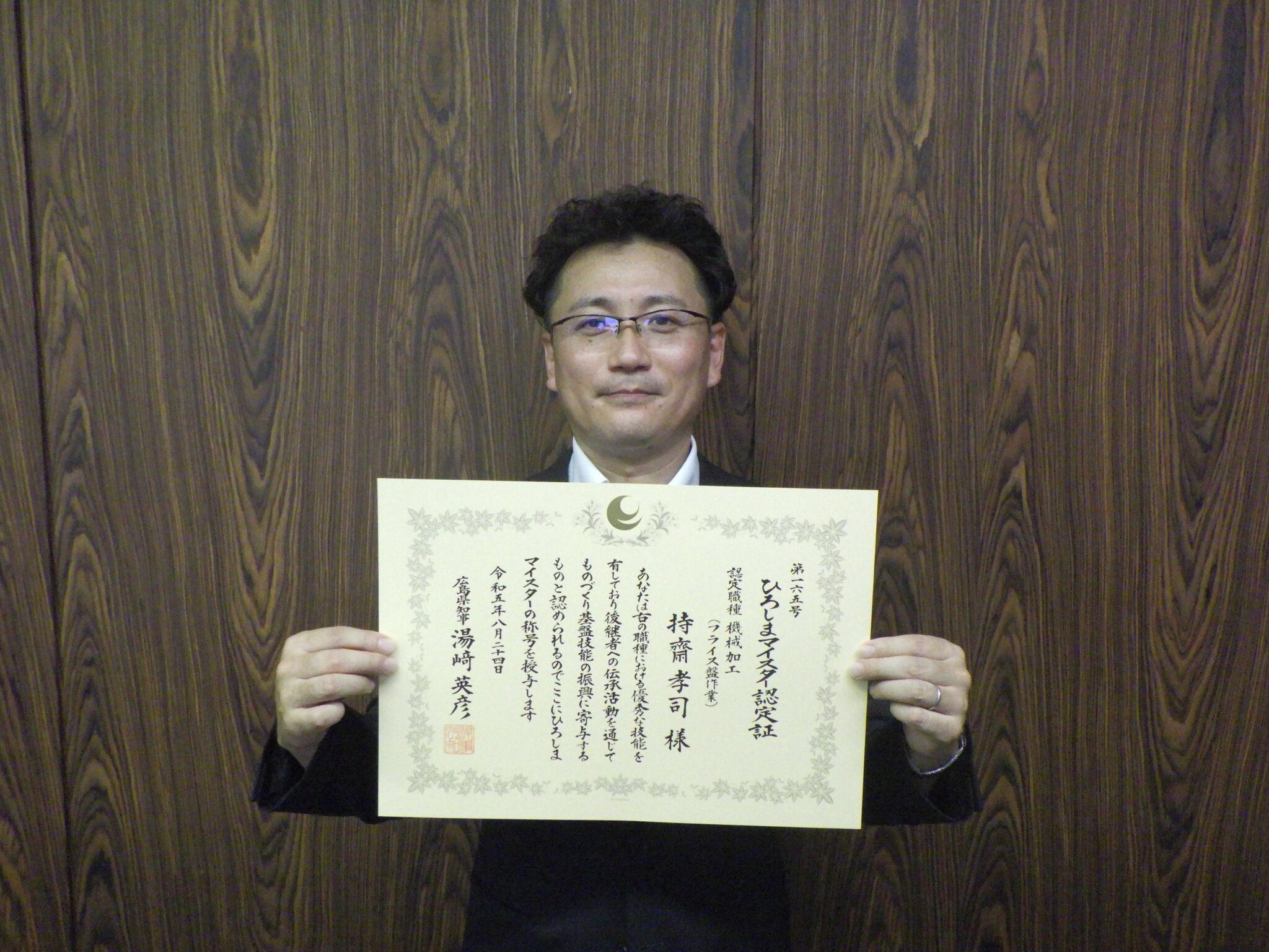 認定書を手にする持齋さん