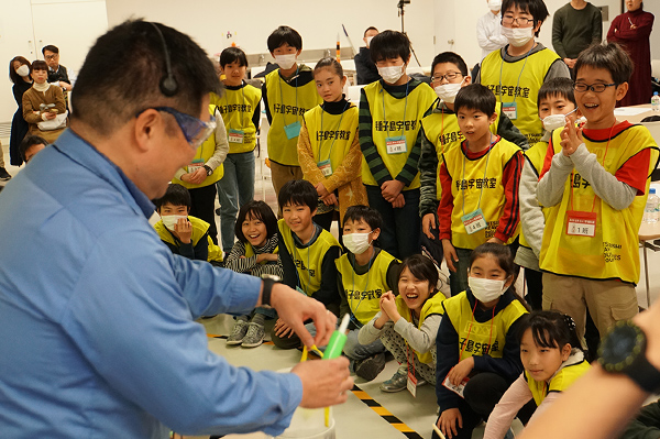 Students excitedly watching an experiment using liquid nitrogen