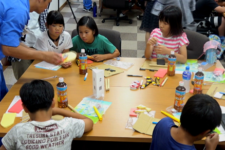 Handicraft class at Shimonoseki Shipyard & Machinery Works. The students built pop-pop boats propelled by steam based on a fast sailing ship theme.