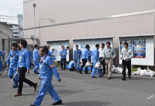 Employees cleaning their local area in Kobe