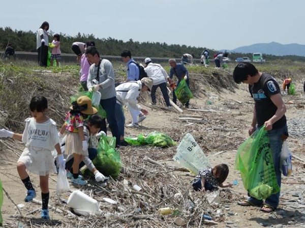 Collecting trash along the shore