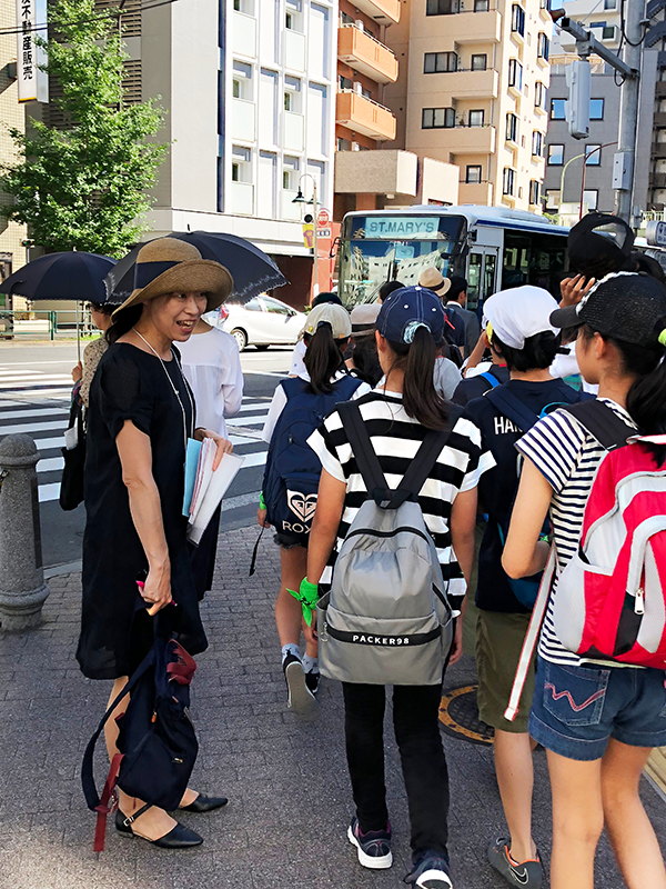 An employee volunteer guiding the young visitors