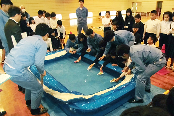 Racing the completed boats in an inflatable pool