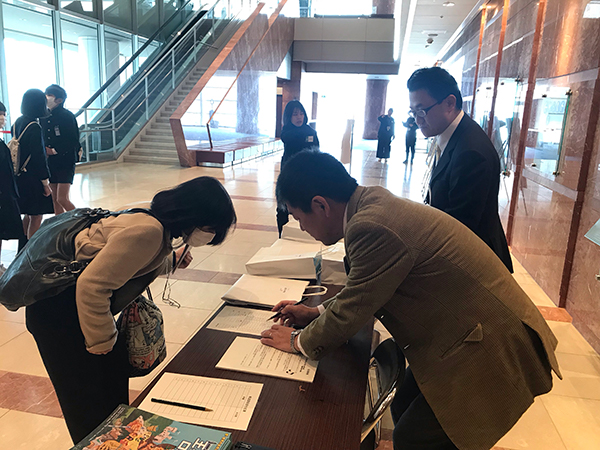 Volunteer employees helping at the reception desk in Takamatsu