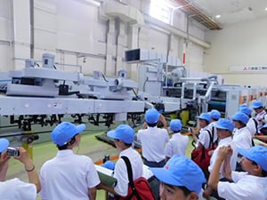 Observing printing machinery in the role of newspaper reporters