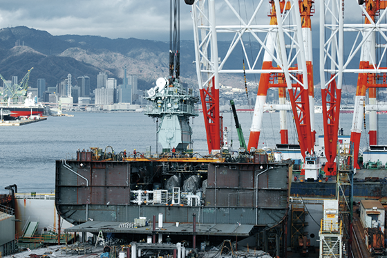 E: A marine crane is used to transfer a giant 20,000 horsepower diesel engine from the yard's engine plant to the engine room.