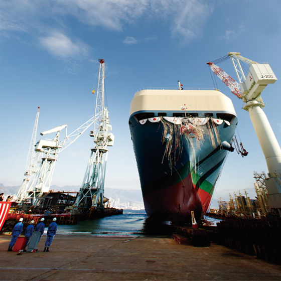 A car carrier is launched by sliding down the sloping building berth into the sea.